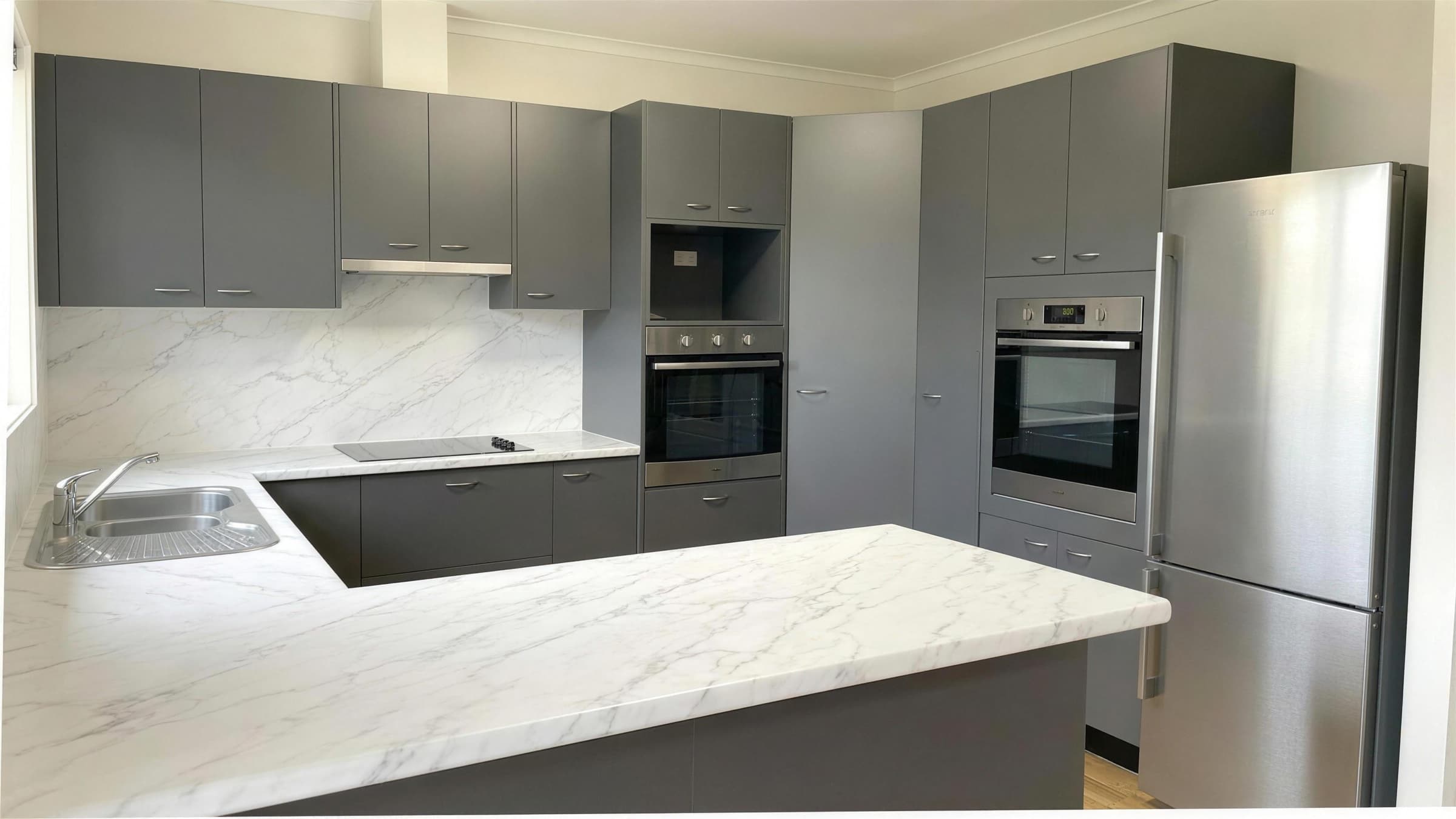 Cuisine rénovée, façades anthracite et plan marbre